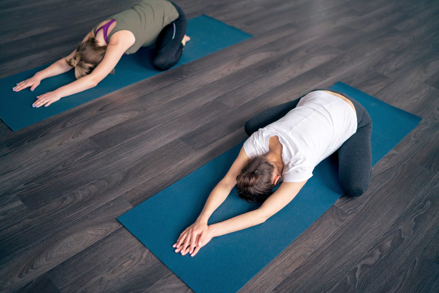 A person practising mobility on a mat